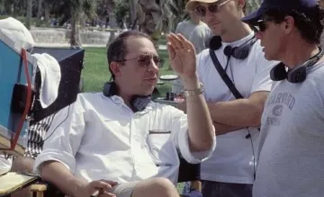 Sonnenfeld (left) discusses a scene on set with producer Barry Josephson (center).